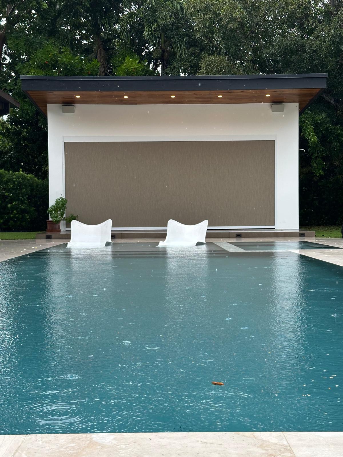 Outdoor screen shade installed by Lavalle Shades on a Miami pool house