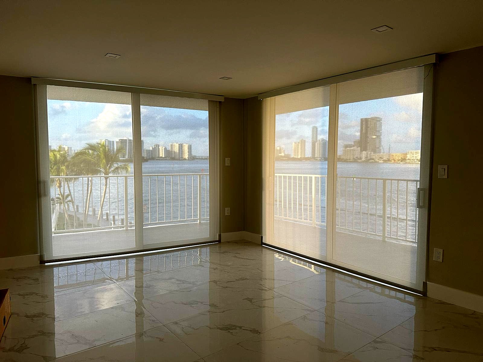 Solar screen roller shades on sliding doors in a waterfront Miami condo, installed by Lavalle Shades