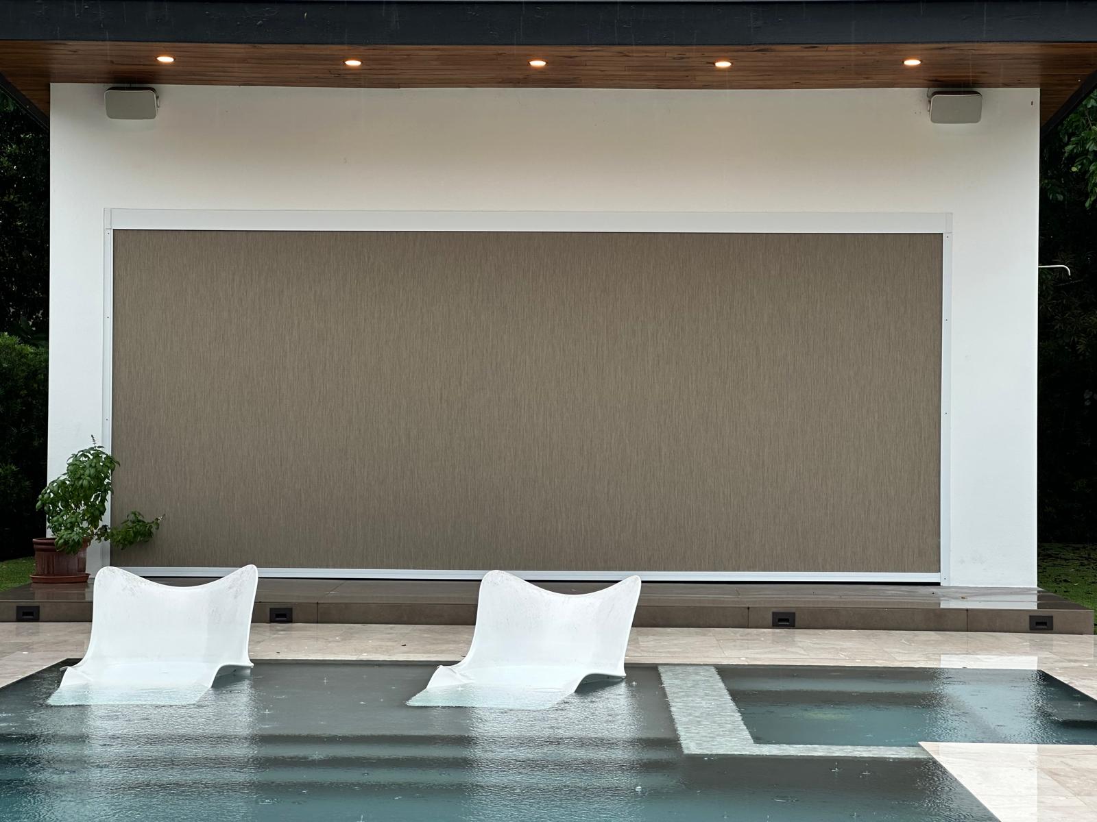 Outdoor screen shade installed by Lavalle Shades behind a pool